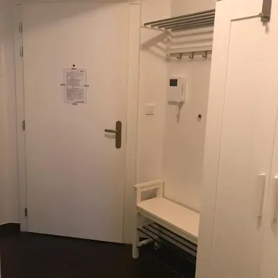 a white door with a bench in a room at Apartmen -Studio in Prague