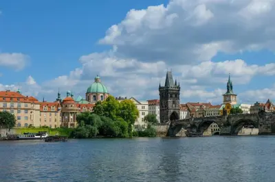 a city with a bridge over a body of water at Modern apartments - Airport 8mins in Prague