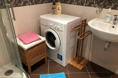 a washing machine in a bathroom next to a sink at Modern apartments - Airport 8mins in Prague