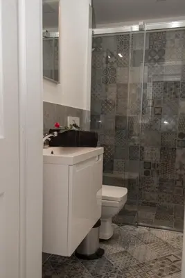 a bathroom with a sink and a toilet and a shower at Apartment Florenc with 3-bathrooms & bedrooms in Prague
