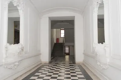 an empty hallway with a black and white checkered floor at Apartment Florenc with 3-bathrooms & bedrooms in Prague