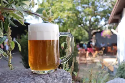 a mug of beer sitting on top of a table at Pivovar Řevnice in Řevnice