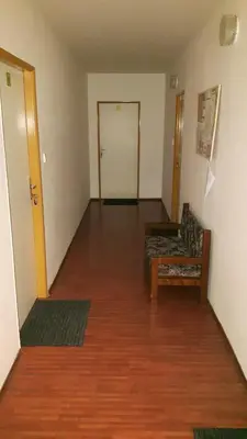an empty room with a couch and a table and a door at Penzion Koupaliště in Litoměřice