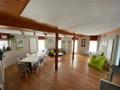 a large living room with a table and chairs at U Vrabčáka in Zlonín