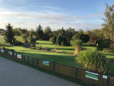 a view of a golf course from behind a fence at U Vrabčáka in Zlonín