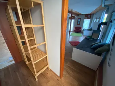 a room with a book shelf and a couch at U Vrabčáka in Zlonín