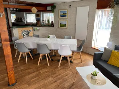 a living room with a dining room table and chairs at U Vrabčáka in Zlonín