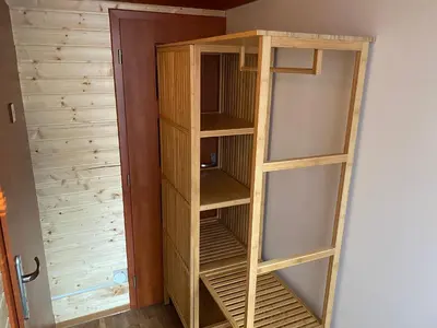 a wooden book shelf in a room at U Vrabčáka in Zlonín