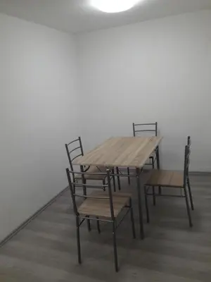 a wooden table and chairs in a room at Apartman V Podbabe in Prague