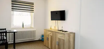 a room with a tv on top of a wooden cabinet at M-Tourist in Prague