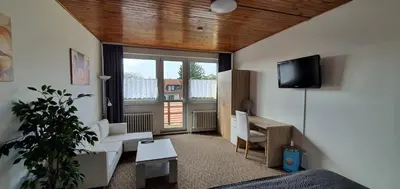 a living room with a tv and a couch and a table at M-Tourist in Prague
