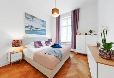 a bedroom with a bed and a wooden floor at Palace Dlazdena Central Apartment - New Town in Prague