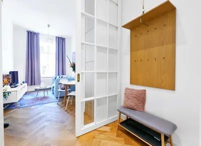a living room with a chair and a table at Palace Dlazdena Central Apartment - New Town in Prague