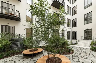 a courtyard with two benches and a building at Palace Dlazdena Central Apartment - New Town in Prague
