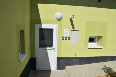 a green wall with a door and a ball on the wall at Apartmány Kosmonosy, Hradištská 181 in Mladá Boleslav