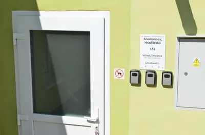 an open door with a sign on a wall at Apartmány Kosmonosy, Hradištská 181 in Mladá Boleslav
