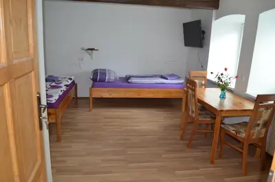 a room with a bed and a table and a dining room at Apartmány Kosmonosy, Hradištská 181 in Mladá Boleslav