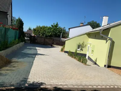 a brick road next to a yellow building at Apartmány Kosmonosy, Hradištská 181 in Mladá Boleslav