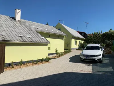 a white car parked in front of a house at Apartmány Kosmonosy, Hradištská 181 in Mladá Boleslav