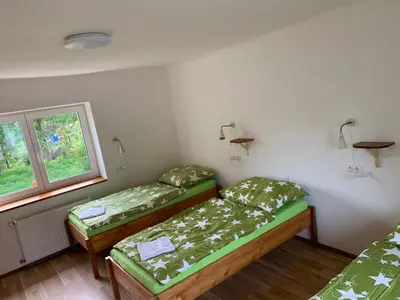 a room with two beds and a window at Apartmány Kosmonosy, Hradištská 193 in Mladá Boleslav