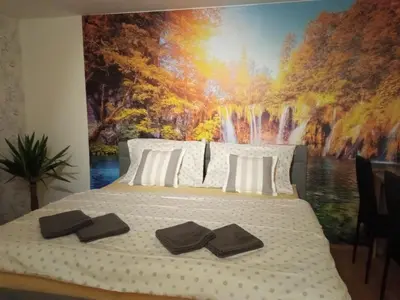 a bedroom with a large waterfall mural on the wall at Celý rodinný dům na venkově in Kouřim