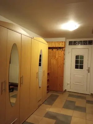 a room with wooden cabinets and a door at Celý rodinný dům na venkově in Kouřim