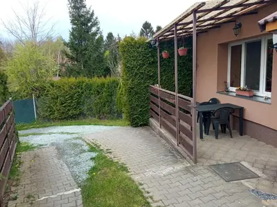 a patio with a table and a fence at Celý rodinný dům na venkově in Kouřim