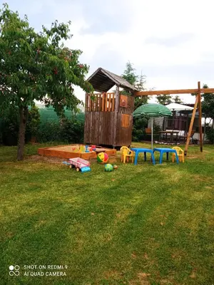 a playground in a yard with a play house at Celý rodinný dům na venkově in Kouřim