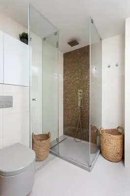 a bathroom with a shower with a toilet and baskets at Prague Days - Sunlit Studio near National Museum in Prague