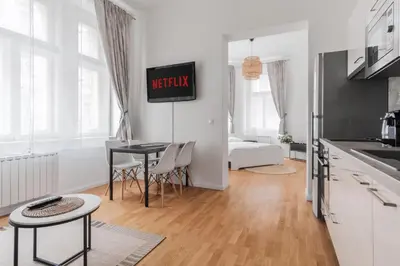 a kitchen and living room with a table and chairs at Prague Days - Sunlit Studio near National Museum in Prague