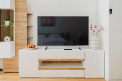 a white cabinet with a tv on top of it at Prague Days - Sunlit Studio near National Museum in Prague