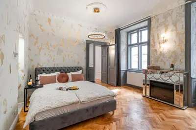a bedroom with a large bed and a fireplace at Emperor Castle View Suite in Prague