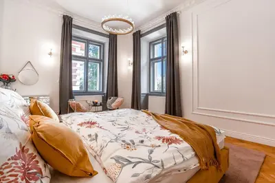 a bedroom with a bed with a floral comforter at Emperor Castle View Suite in Prague