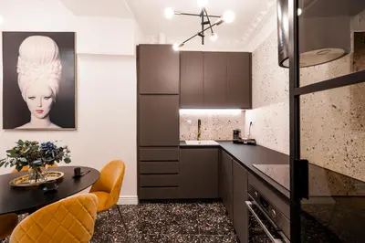 a kitchen with a black counter and a table at Emperor Castle View Suite in Prague