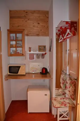 a small kitchen with a microwave and a counter at Pension U akátu in Prague