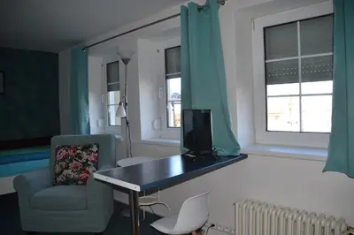 a room with a desk and a chair and a television at Pension U akátu in Prague