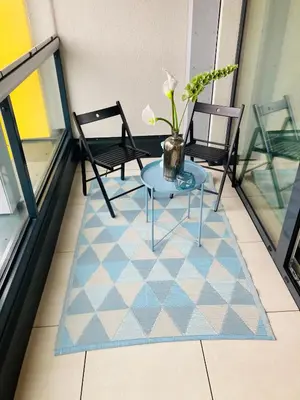 a balcony with a table and two chairs on a floor at Apartement Blanc Harfa design in Prague