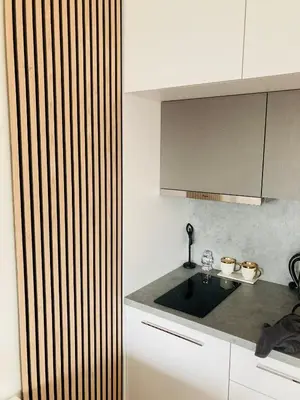 a kitchen with a sink and a counter top at Apartement Blanc Harfa design in Prague