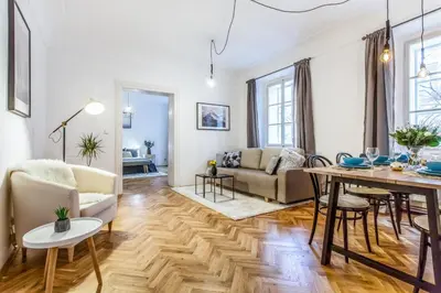 a living room with a table and a couch at Old Town 2 BDR apartment, free coffee in Prague