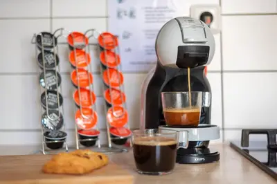 a coffee maker is making a cup of coffee at Old Town 2 BDR apartment, free coffee in Prague