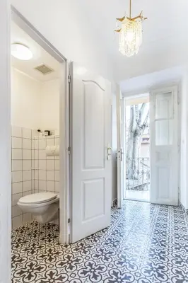 a bathroom with a white door and a toilet at Old Town 2 BDR apartment, free coffee in Prague