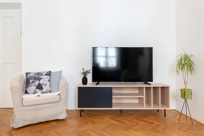 a living room with a flat screen tv on a entertainment center at Old Town 2 BDR apartment, free coffee in Prague