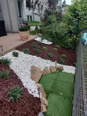 a garden with rocks and plants in a yard at Apartmán Residence Nábřeží in Beroun