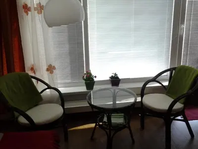 two chairs and a table in front of a window at Apartmán Residence Nábřeží in Beroun