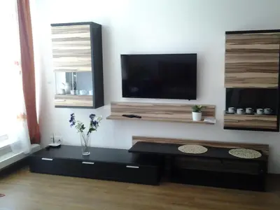 a living room with a flat screen tv on a wall at Apartmán Residence Nábřeží in Beroun