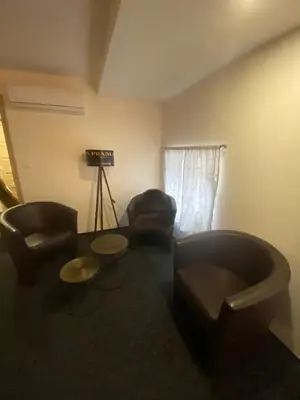 a living room with a couch and a chair at WELLNESS APARTMÁN KAROLÍNA in Milovice