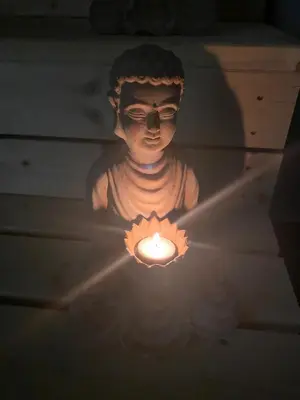 a statue of a person holding a candle at WELLNESS APARTMÁN KAROLÍNA in Milovice