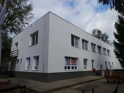 a white building with windows on the side of it at Ubytovna Koupaliště in Litoměřice