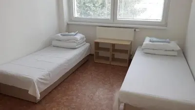a small room with two beds and a window at Ubytovna Koupaliště in Litoměřice