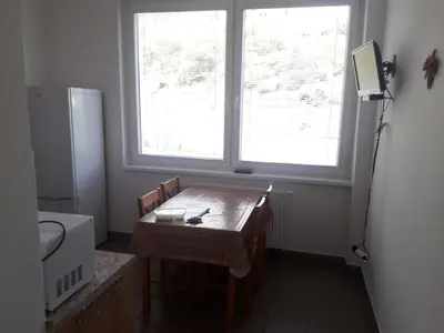a small bathroom with a table and a window at Ubytovna Koupaliště in Litoměřice